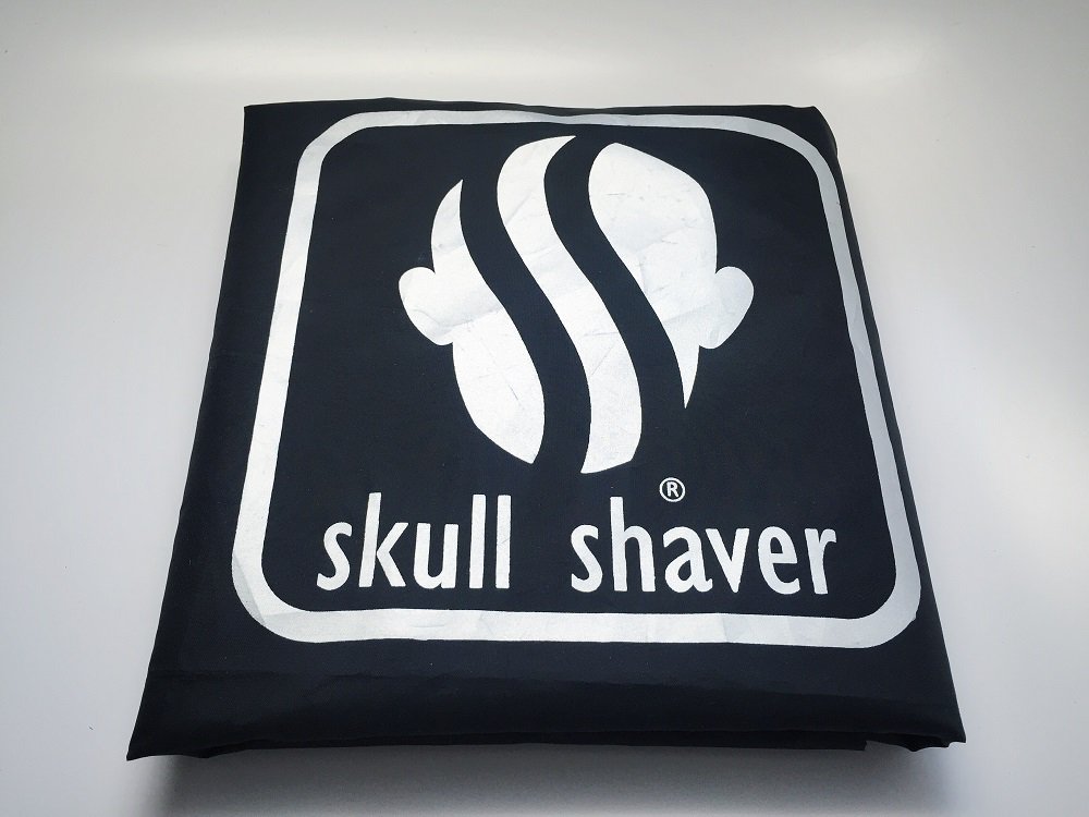 a man using skull shaver pitbull gold pro shaver on head for smooth shave